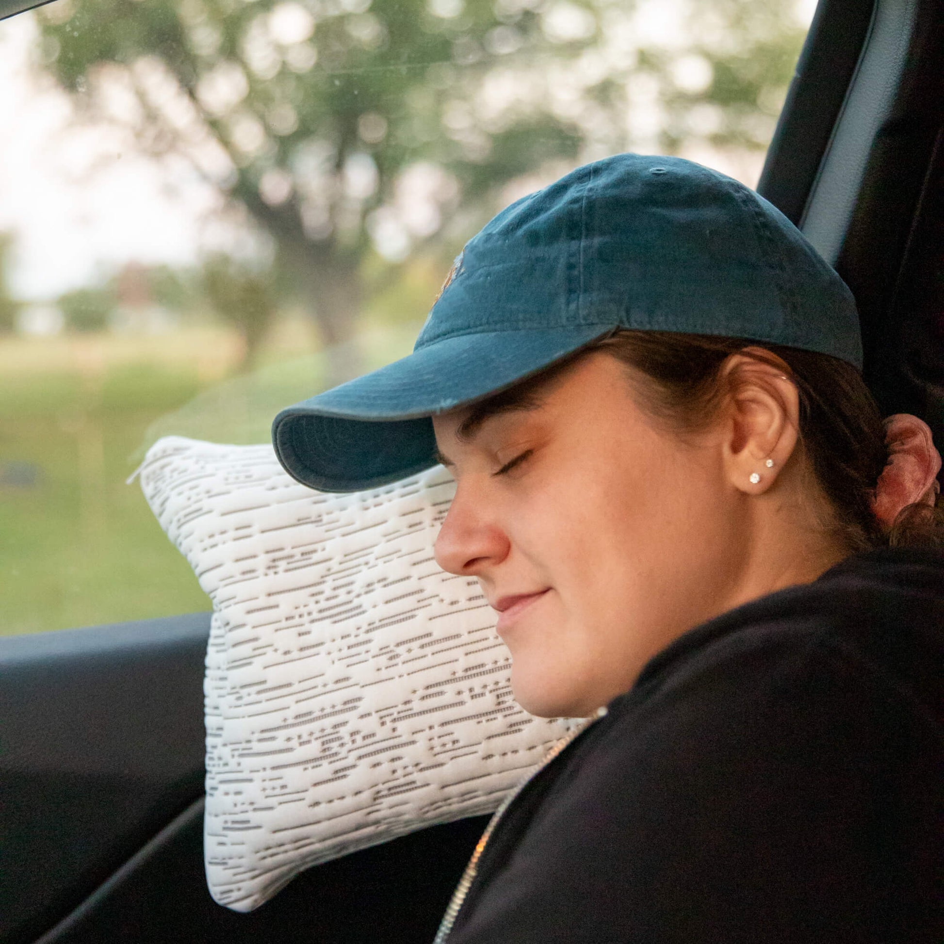 Buckwheat Travel Pillow Size 10" x 14" being used in a car on a roadtrip