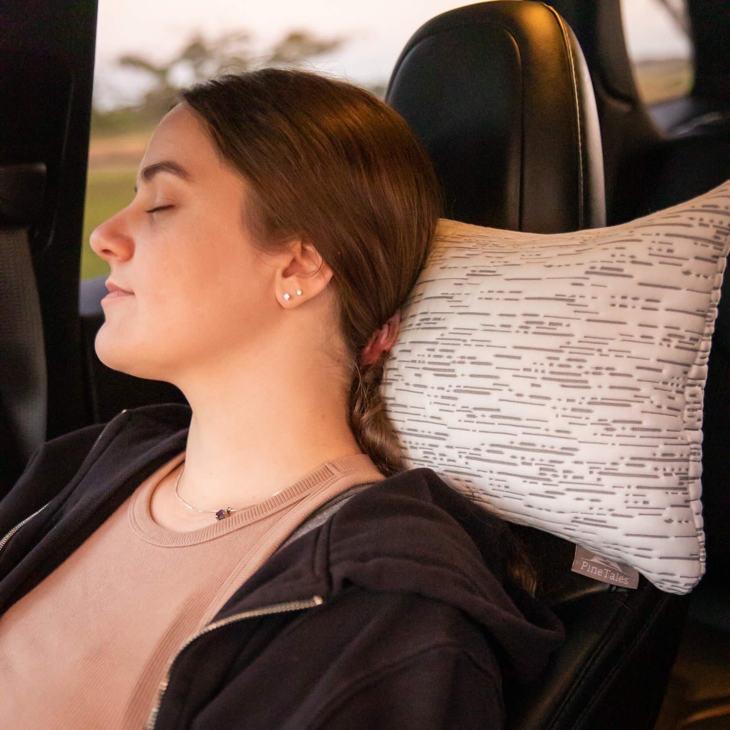 Buckwheat Travel Pillow used in front seat of a car by passenger