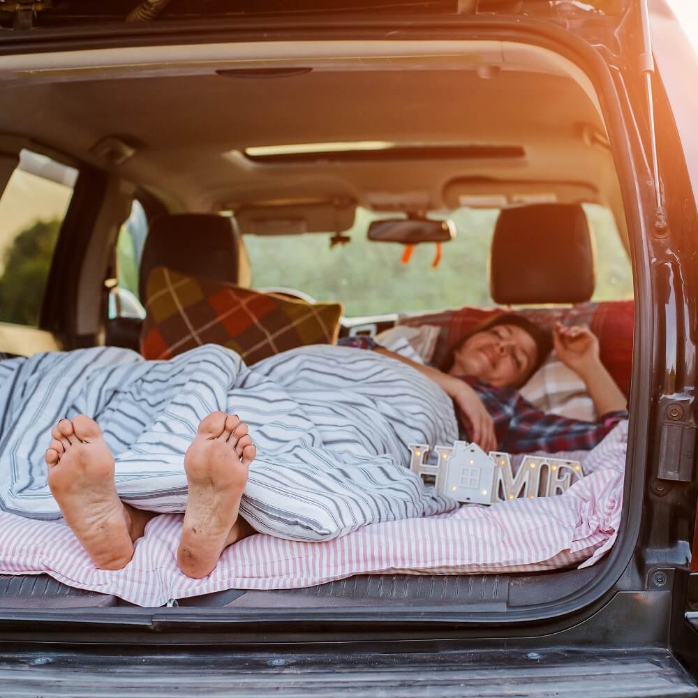 PineTales Travel Pillow Lifestyle Image2 Woman Sleeping in Car