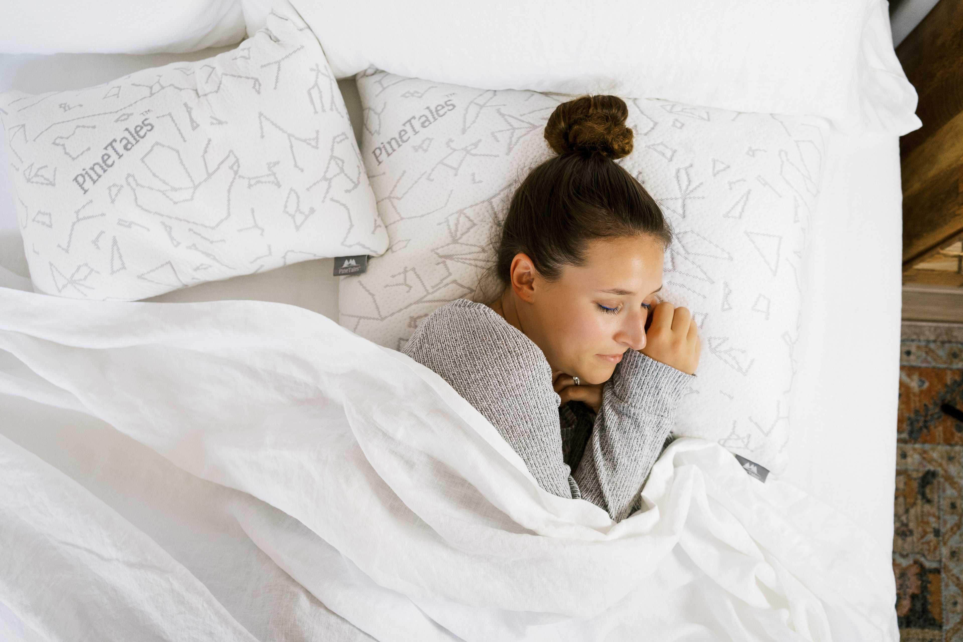 Homepage Banner Image showing a young woman sleeping on a king size pinetales buckwheat pillow